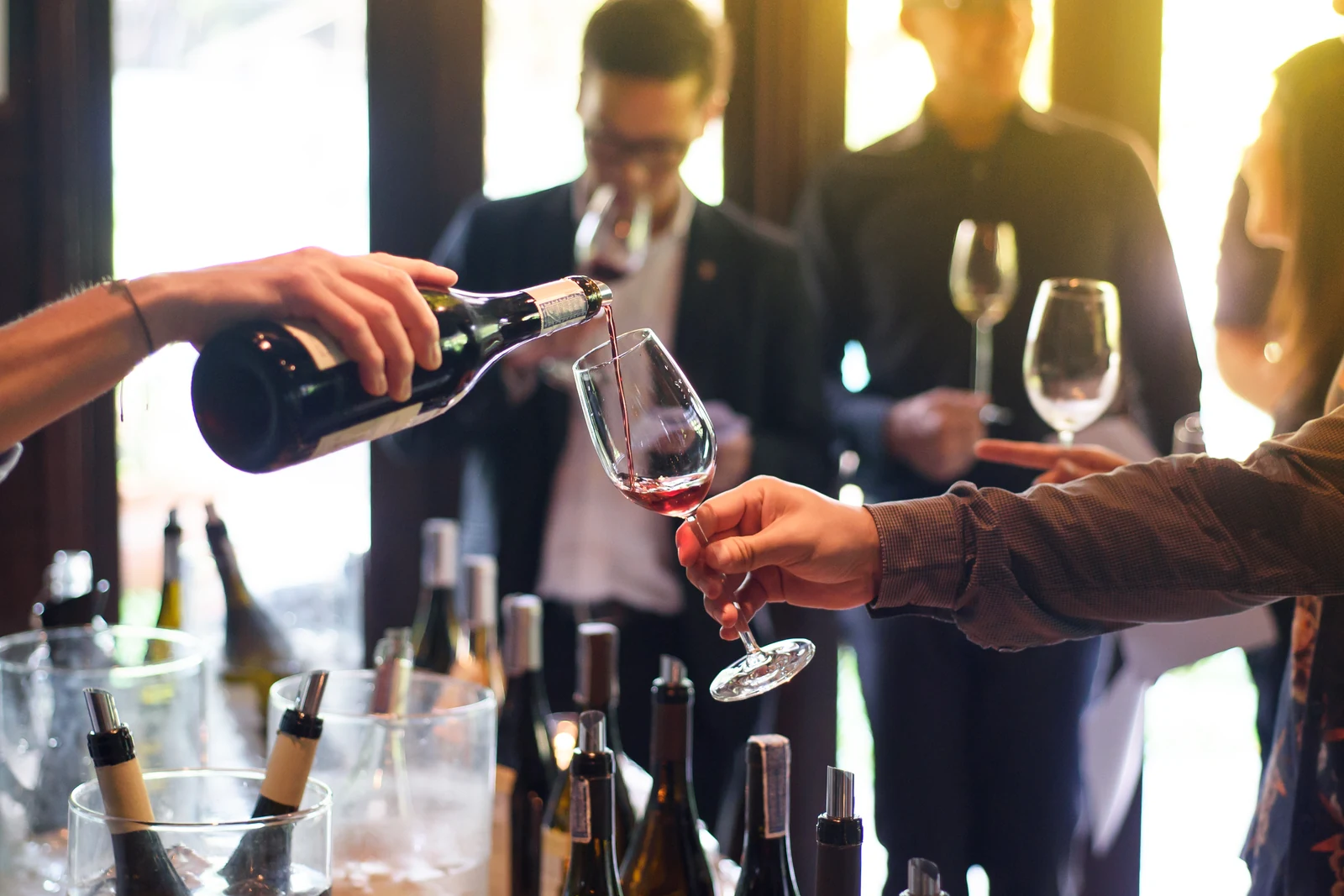 Red wine being poured into a glass at a cellar door tasting
